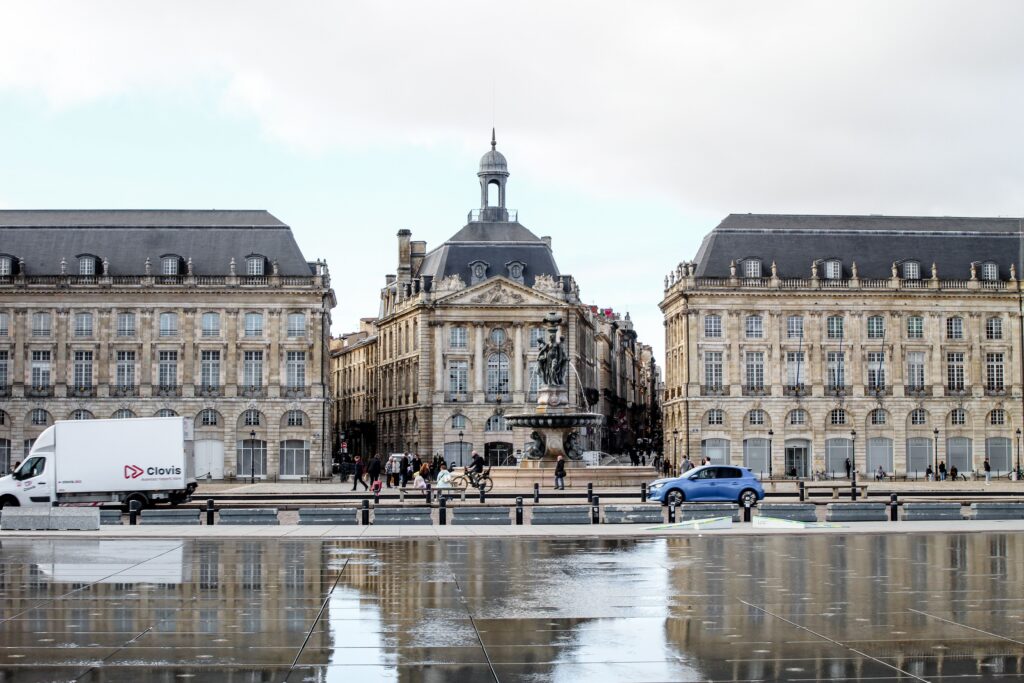 Stunning view of Place de la Bourse in Bordeaux with reflection on wet pavement.